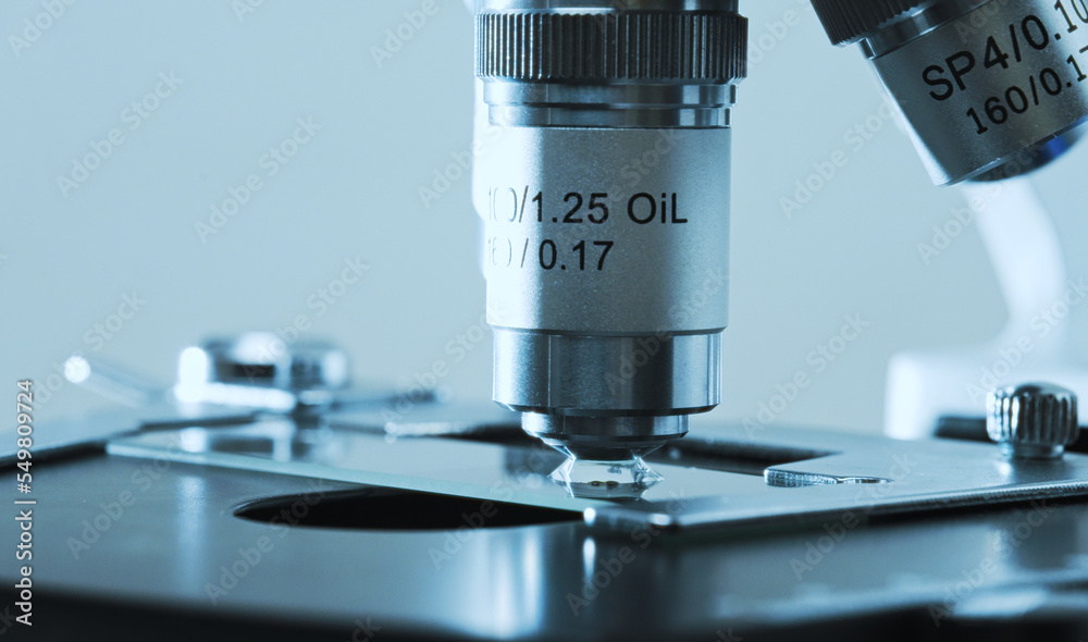 Macro view of Microscope and slide. Science and Healthcare Technology. Macro view of Microscope and slide. Science and Healthcare Technology.