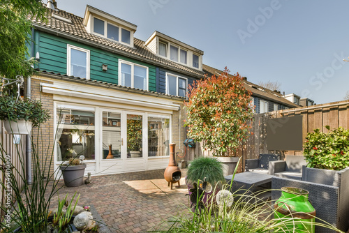 Residential house against patio with plants and sofa