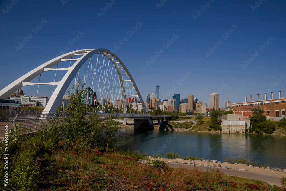 Modern arc bridge over the river,  day traffic, summer time. modern architecture, panorama of the city Edmonton