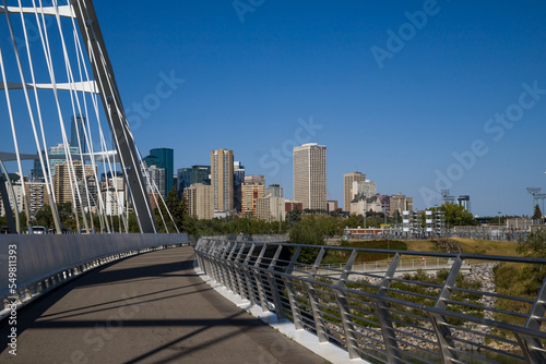 Modern arc bridge over the river, day traffic, bike road, summer time. modern architecture, panorama of the city Edmonton