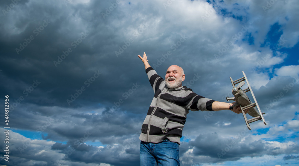 retired granddad with toy. retired old man. senior man at retirement on sky background. copy space. retired granddad with toy. retired old man. senior man at retirement on sky background. copy space.