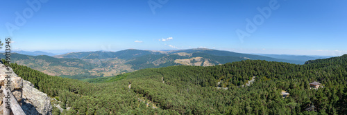 Panoramic view of high mountains covered by green pine forest in Neila lagoons natural park at daylight, Neila, Burgos, Spain