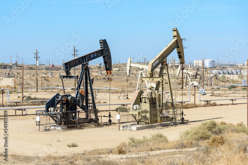 Oil field in under blue sky in  autumn. California, USA.