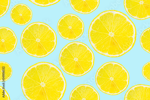 Summer seamless pattern. Lemon slices on a light blue background.