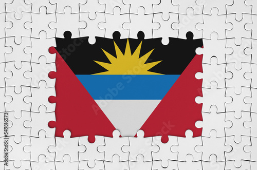 Antigua and Barbuda flag in frame of white puzzle pieces with missing central part photo