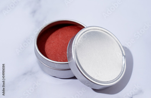 red lip balm in round tin case with shadow overlay, mockup design