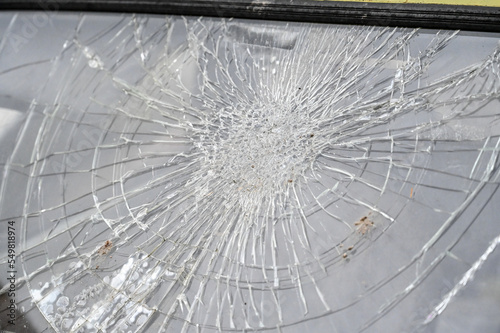Broken car windshield with cracks. Smashed glass, close up. Cracked glass in accident.