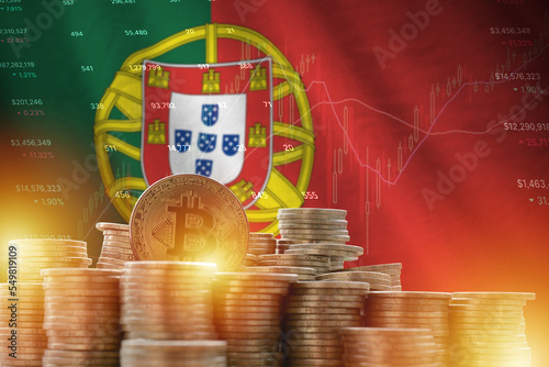 Portugal flag and big amount of golden bitcoin coins and trading platform chart. Crypto currency photo