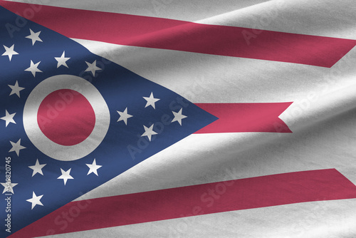 Ohio US state flag with big folds waving close up under the studio light indoors. The official symbols and colors in banner photo