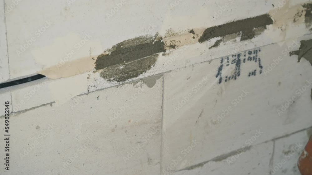 Video „Male construction worker securing electric cables installed in