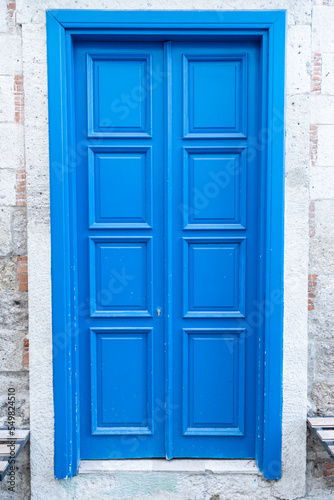 Charming House with wooden old blue door.
