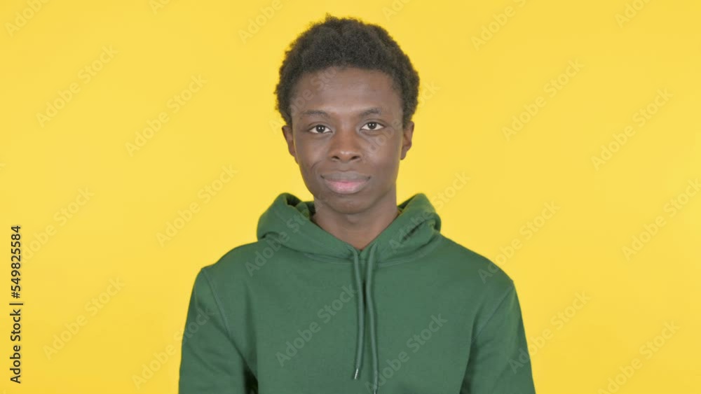 Denying Young African Man Rejecting Idea on Yellow Background Denying Young African Man Rejecting Idea on Yellow Background