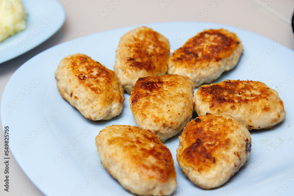 chicken cutlets on a blue plate