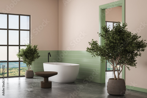 Interior of modern bathroom with green tiles and beige walls  concrete floor  double white sink on marble countertop with oval mirrors above it and comfortable white bathtub. 3d rendering