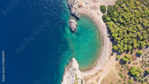 Aerial drone top down photo of beautiful half moon beach in tropical exotic island bay with deep turquoise sea © aerial-drone