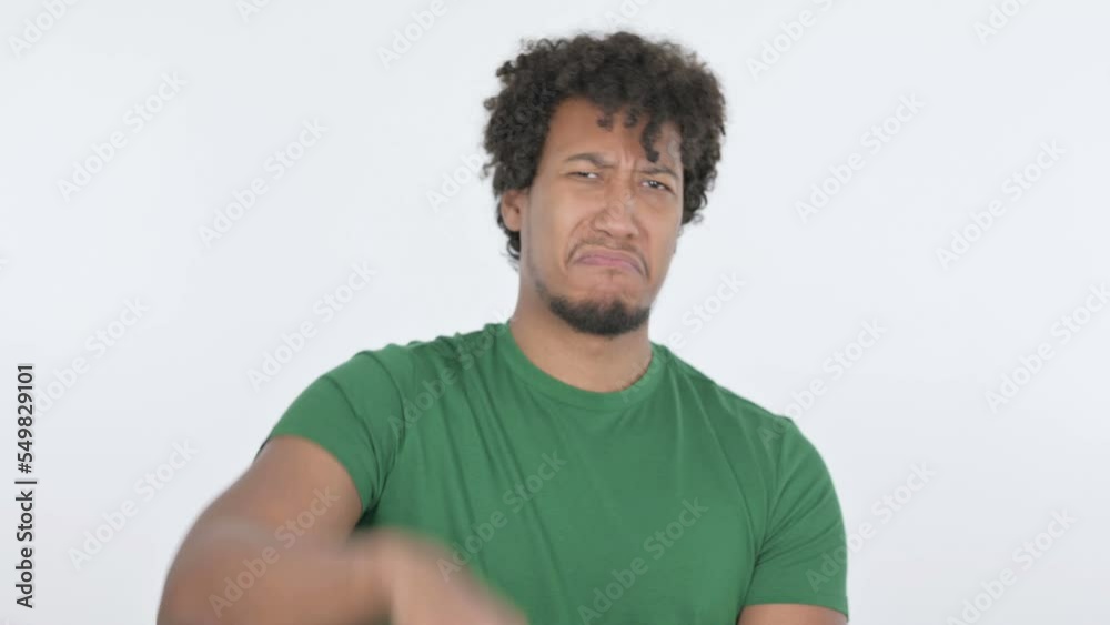 Thumbs Down by African Man on White Background