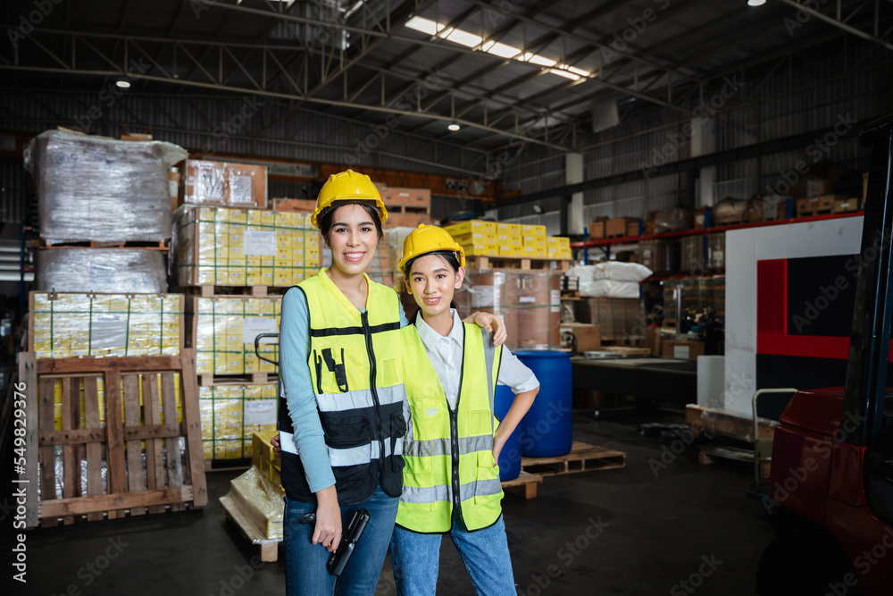 Portrait of a Happy warehouse worker in a warehouse or storehouse while looking at camera. Portrait of a Happy warehouse worker in a warehouse or storehouse while looking at camera.