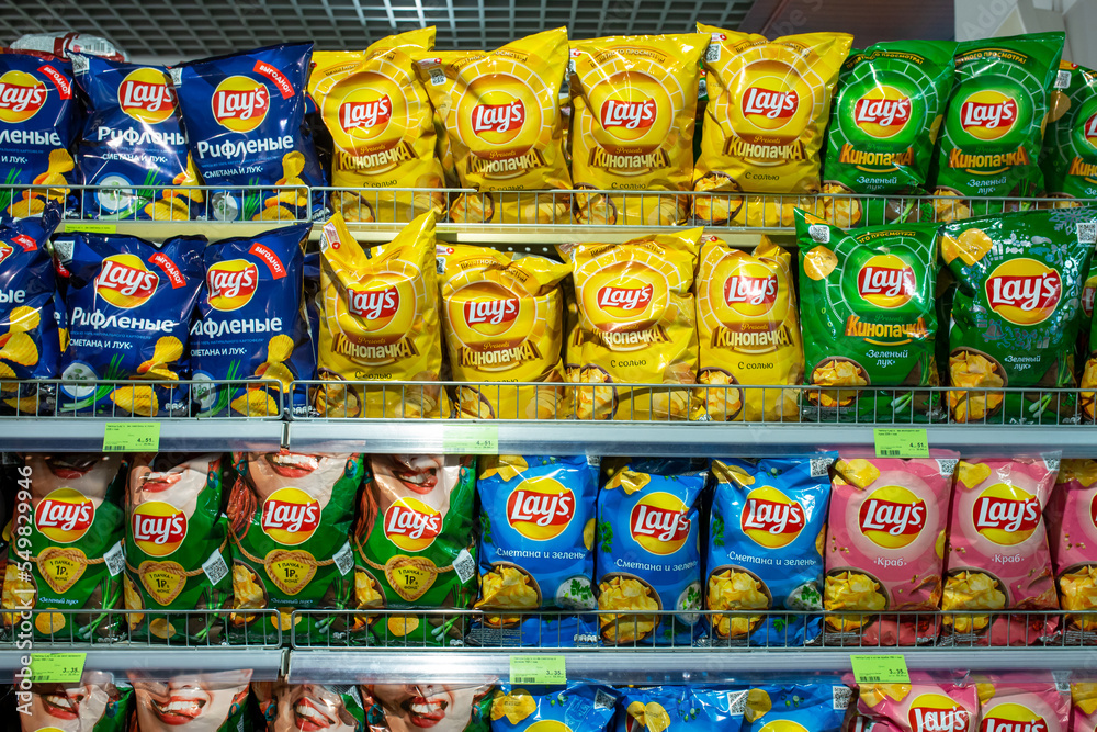 Various flavoured of Lay's Potato Chips on grocery store shelves. Minsk
