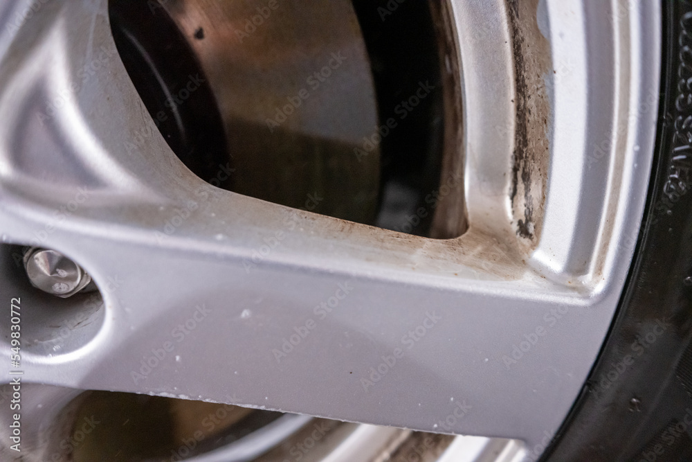 Dirty aluminium rimsof a car about to be washed.