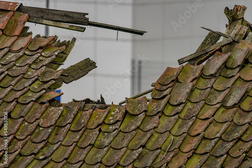 Fototapeta Naklejka Na Ścianę i Meble -  Old broken roof of an abandoned barn.