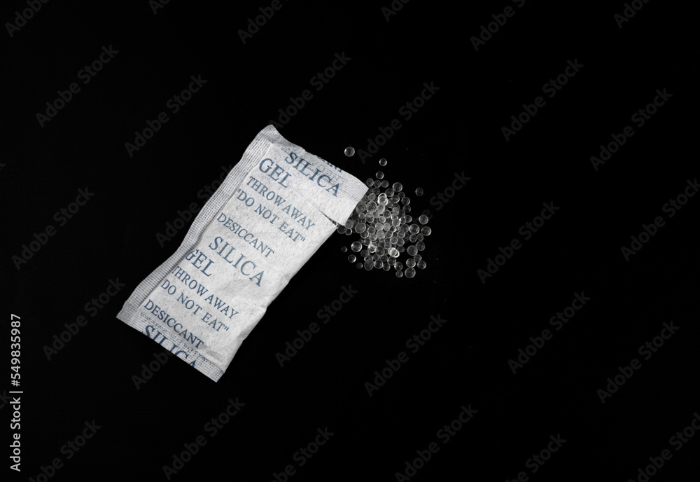 Naklejka premium Desiccant Silica Gel Adsorbent Crystals on Black Background, Desiccant Polymer Balls