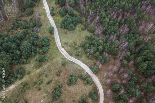 Aerial view of gravel forest road, Latvia.