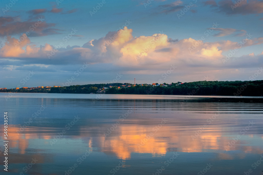 beautiful clouds in the evening sky at landscape of Ternopil city lake water reflection