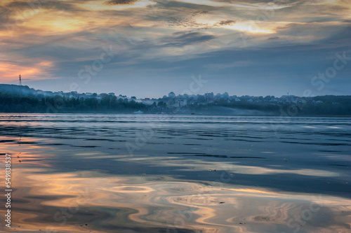 Ternopil lake with fog and embankment with evening sky. Ternopil, Ukraine