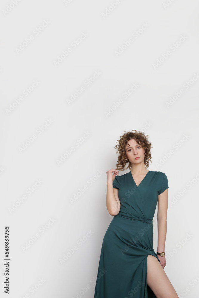 Serie of studio photos of young female model in green viscose wrap dress. Serie of studio photos of young female model in green viscose wrap dress.