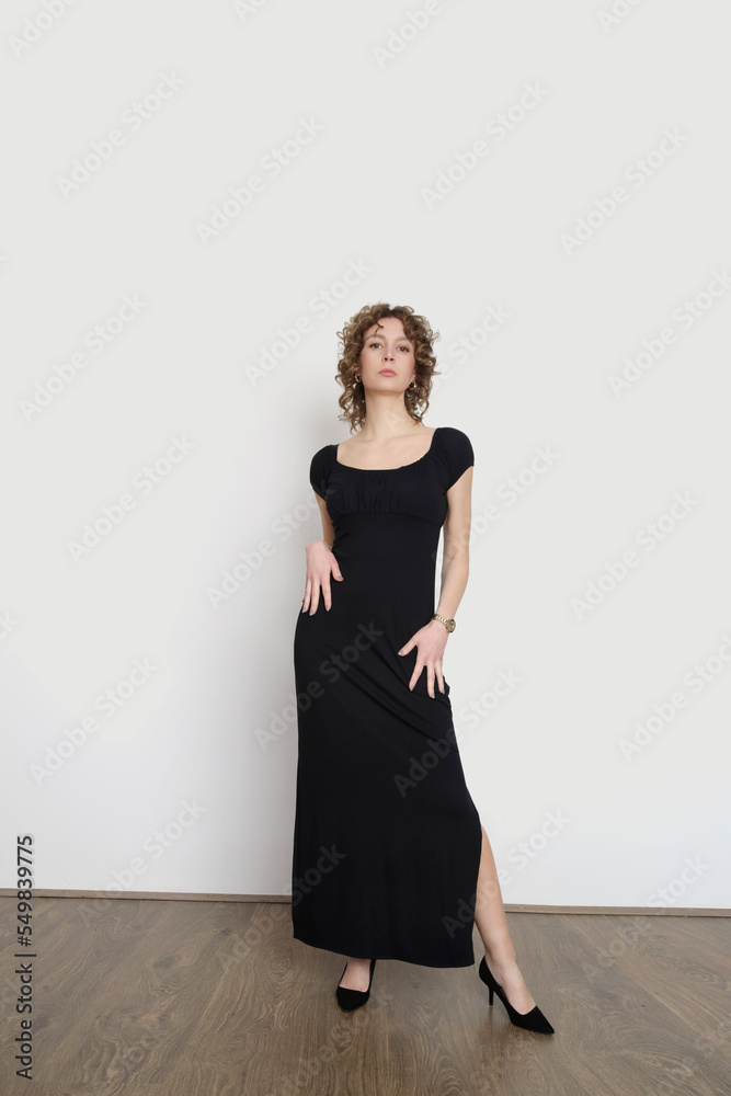 Serie of studio photos of young female model in long elastic black classic and versatile off the shoulder dress
Serie of studio photos of young female model in long elastic black classic and versatile off the shoulder dress