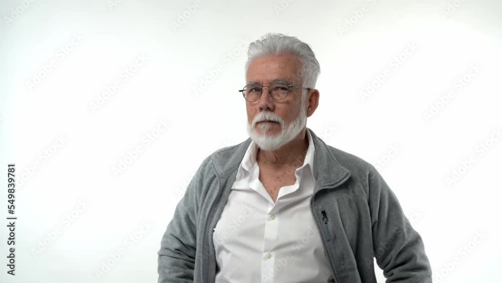 Portrait of a retired man stands in a pose with a serious face, thinking concentrated in experiences. On a white background Portrait of a retired man stands in a pose with a serious face, thinking concentrated in experiences. On a white background
