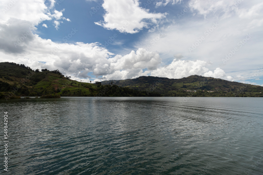 Guavio reservoir dam landscape with gachala town mountains in sunny blue sky day