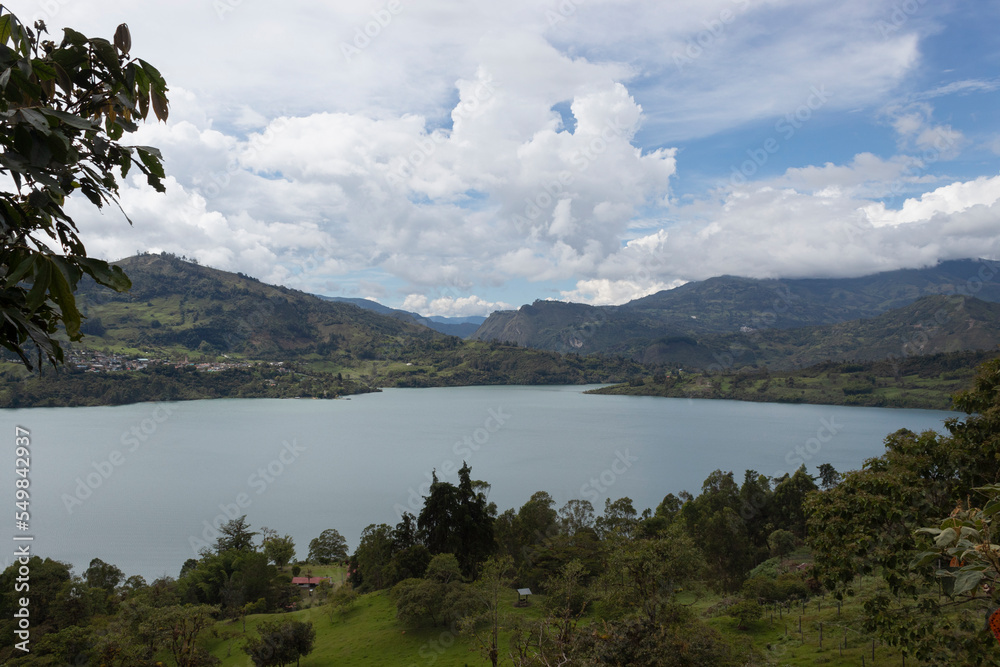 Colombian guavio reservoir lake landscape with andean mountain range and blue cloudy sky in sunny day