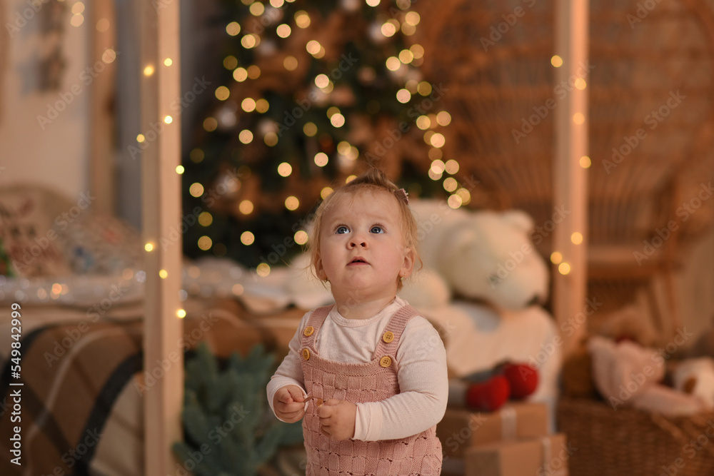 little child playing with christmas tree. child with christmas presents little child playing with christmas tree. child with christmas presents
