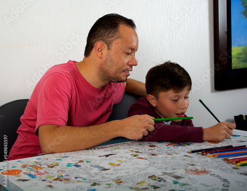 Dad teaches his son how to paint.