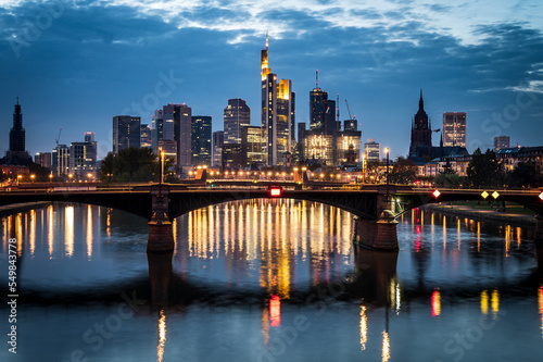 Frankfurt skyline with its reflections in the river Main during blue hour