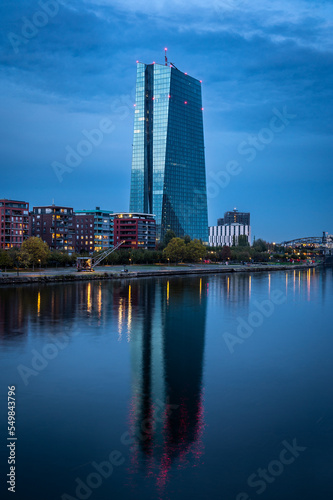 European central bank with reflections in river Main during blue hour