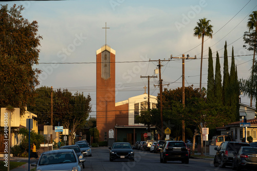 Sunset illuminates a church in a downtown neighborhood of Artesia, California, USA. photo