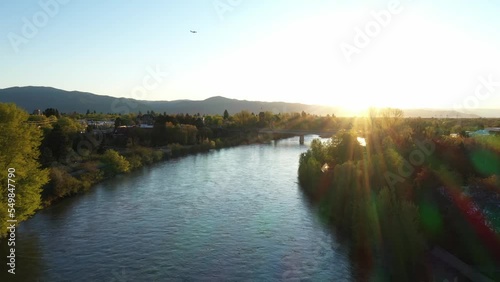 Aerial view of Clark Fork River flowing through Missoula city surrounded by mountains photo