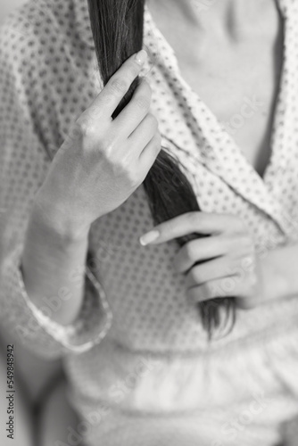 female hands hold long smooth hair. closeup