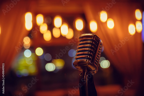 Metal microphone on blurred background close-up