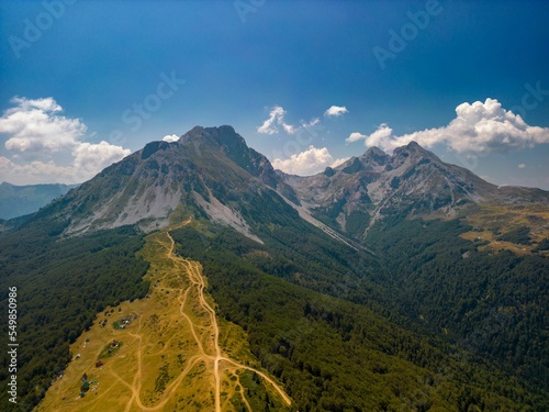 Aerial shot of green-covered mount Komovi under the blue sky in  Montenegro photo