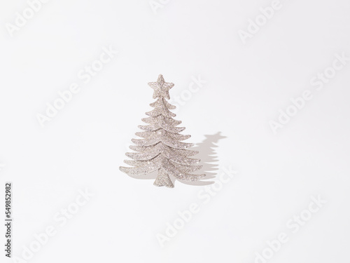 Silver glitter decorative Christmas tree on a white background. Minimal design.