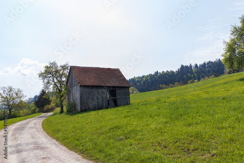 Gravel road to an old wooden Barn in Germany