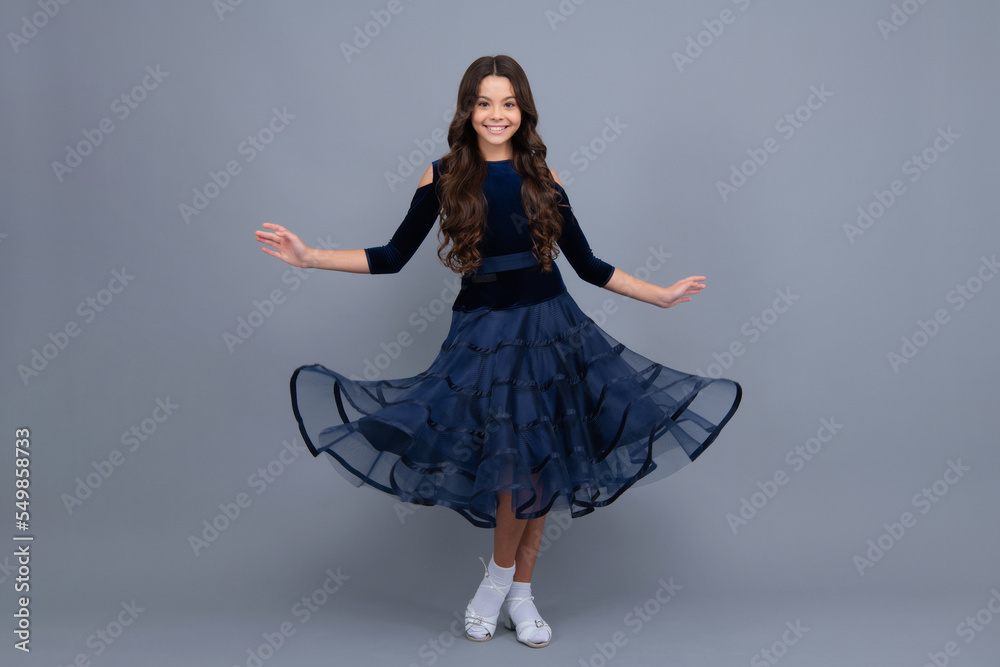 Happy girl face, positive and smiling emotions. Movement dress of young child teen girl. Full length of teenager child wearing ball dress. Happy girl face, positive and smiling emotions. Movement dress of young child teen girl. Full length of teenager child wearing ball dress.