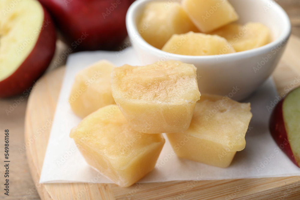 Frozen apple puree cubes and ingredient on wooden table, closeup Frozen apple puree cubes and ingredient on wooden table, closeup