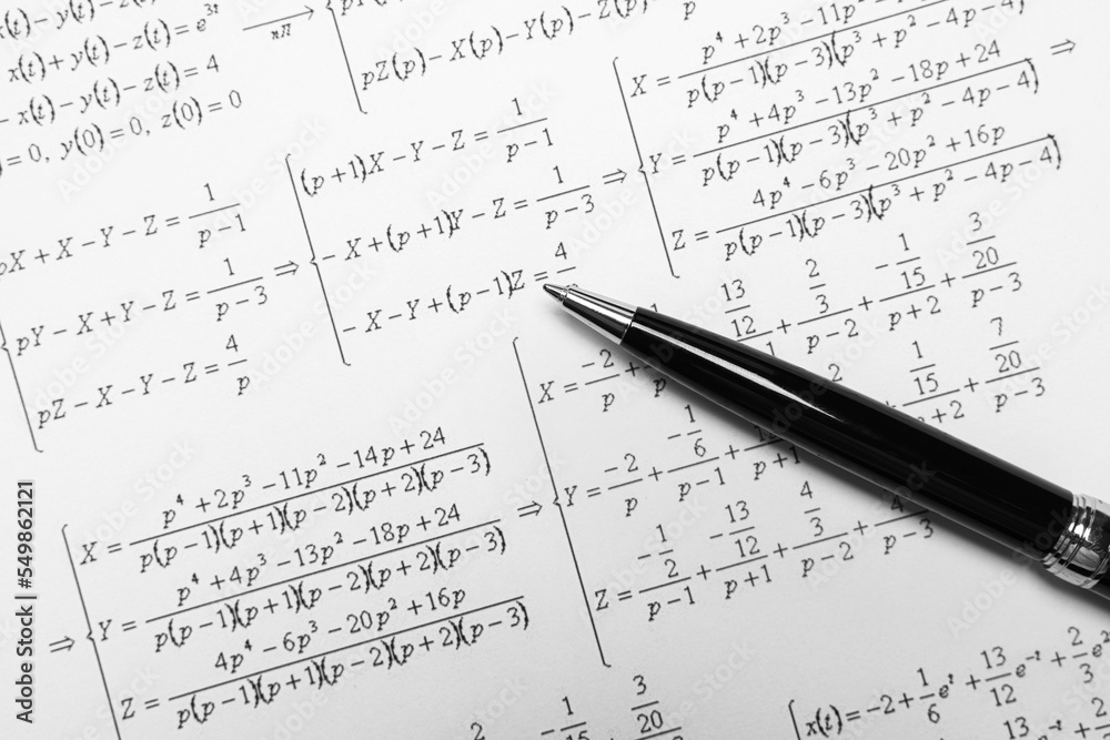 Sheet of paper with mathematical formulas and pen Sheet of paper with mathematical formulas and pen