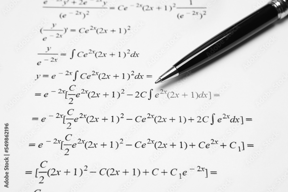 Sheet of paper with mathematical formulas and pen, closeup Sheet of paper with mathematical formulas and pen, closeup