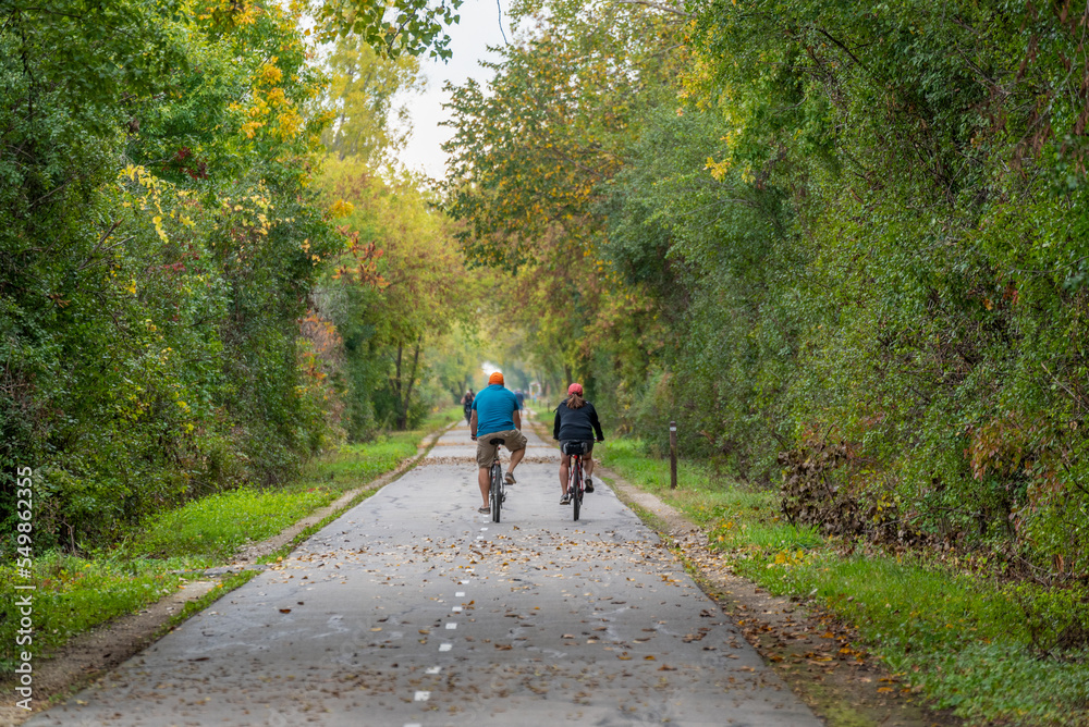 Bicycle Riders On The Local Trail In Fall