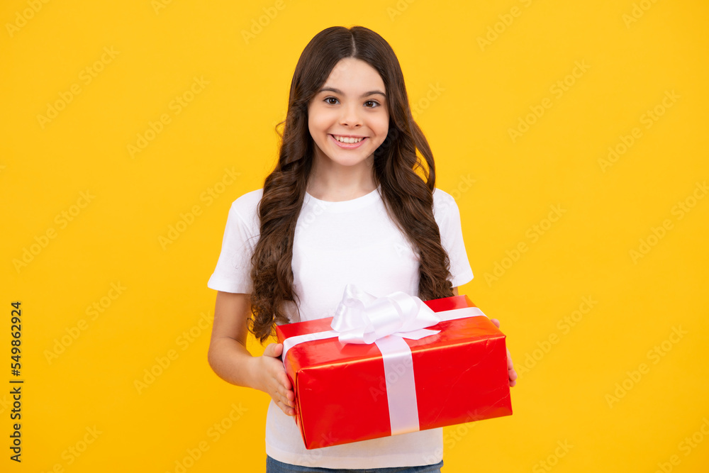 Child with gift present box on isolated background. Presents for birthday, Valentines day, New Year or Christmas. Happy teenager, positive and smiling emotions of teen girl. Child with gift present box on isolated background. Presents for birthday, Valentines day, New Year or Christmas. Happy teenager, positive and smiling emotions of teen girl.